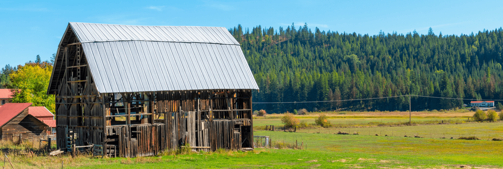  vintage rustic barn with metal roof in the rural mountain town of Athol, in the Coeur d'Alene, Idaho area